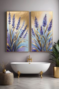 two paintings are hanging on the wall above a bathtub in front of a potted plant