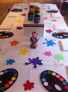 the table is set up with colorful paintbrushes