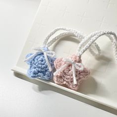 two crocheted hearts on a white tray