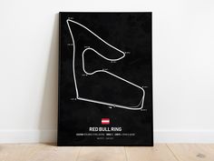 a black framed poster with a red bullling track map on the front and side