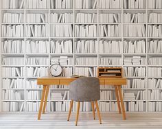 a desk and chair in front of a bookshelf with a clock on it