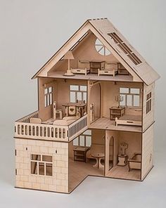 a wooden doll house with all the furniture in it