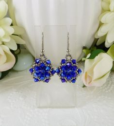 Woven Crystal Earrings Cobalt Blue and Sapphire These sparkling Sapphire Swarovski crystal rivoli stones have tons of depth and are hand woven with tiny pewter colored seed beads and Cobalt blue AB bicone crystals. They measure approximately  .75" across and approximately 1.75" from the top of the hook style ear wires. A beautiful, sparkling earring. https://www.etsy.com/shop/IndulgedGirl Pewter Color, Sparkle Earrings, Cobalt Blue, Cobalt, Crystal Earrings, Seed Beads, Swarovski Crystals, Sapphire, Jewelry Earrings Dangle