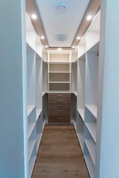 an empty walk in closet with shelves and drawers