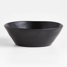 a black bowl sitting on top of a white table