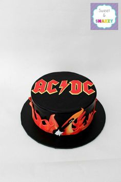 a black hat with flames on it and the word ac / dc painted on top