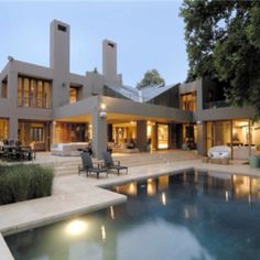 a large house with a pool in front of it