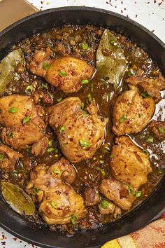 a skillet filled with chicken and vegetables