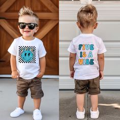 two toddlers wearing matching t - shirts and shorts, one with sunglasses on his head