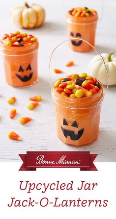 pumpkin jars filled with candy corn and jack - o'- lanterns