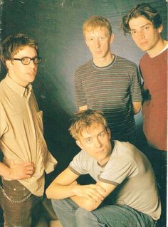 four young men are posing for the camera