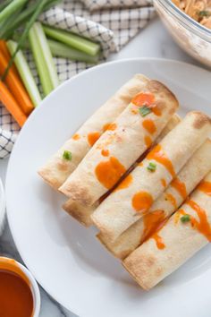 some food is on a white plate with carrots and celery in the background