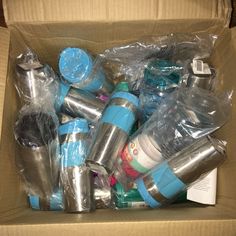 a cardboard box filled with different types of cups