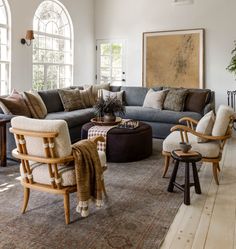 a living room filled with furniture and windows