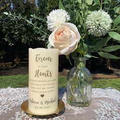 a vase with flowers and a candle on a table