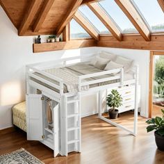 a loft bed with a desk underneath it in the middle of a wooden floored room