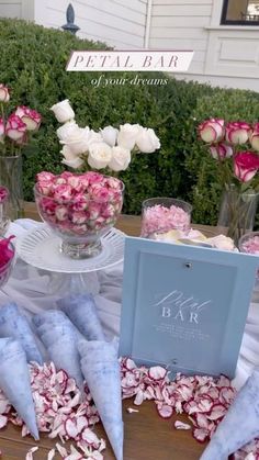 a table topped with vases filled with pink and white flowers