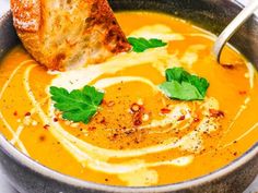 a close up of a bowl of soup with bread