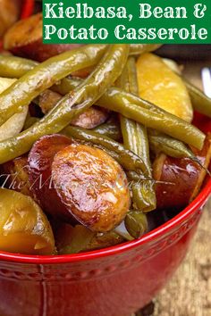 a red bowl filled with green beans and potatoes