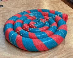 a blue and red striped object sitting on top of a wooden table