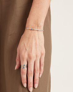 A Vibe signature, The Hook Bracelet with Stone is fashioned in gently hammered sterling silver with a faceted blue zircon stone and "C" hook clasp. Featuring a replica of the St. John petroglyph and seven good luck wraps, solo or stacked, it is sure to be a favorite piece. Found in many of our designs, Vibe’s seven good luck wraps represent love, laughter, happiness, good fortune, health, unity, and peace. In the Caribbean tradition, wear your hook facing in to keep love close to your heart, and Bracelet With Stone, Triple Band Ring, Hook Bracelet, Gold Wrap, Hammered Sterling Silver, The Hook, Hook Clasp, Blue Zircon, Blue Gemstones