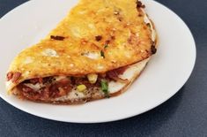 a white plate topped with a quesadilla on top of a blue table