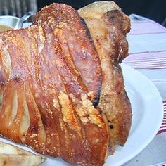 a large piece of bread sitting on top of a white plate next to french fries