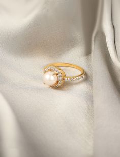 The Lust for Pearl Ring is expertly crafted to make a statmenet, offering a contemporary take on a traditional and luxurious piece of jewelry. This Lust for Pearl Ring features a 2.55 Ct pearl and 0.98 Ct cubic zirconia. Made with 2.13 Gms of metal, the gross weight is 2.84 Gms. With a 7.5 US size, this ring exudes elegance and sophistication for any occasion. Pearl Ring, Jewelry Pouch, Precious Metals, Crafts To Make, Jewelry Pieces, 925 Silver, Cubic Zirconia, Ring, Stone