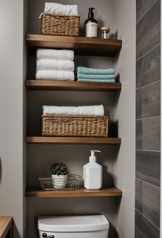 the shelves in this bathroom are filled with towels and toilet paper, along with other items