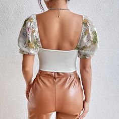 The Floral Corset Top blends vintage elegance with a modern, feminine touch. Delicate lace and floral detailing complement the structured bustier with padded cups and a central floral applique. Puff sleeves and a cropped fit complete its romantic style, perfect with high-waisted skirts or jeans. Lace material Floral pattern Pink rose detail on chest Usable as off shoulder Sheer sleeves Wired cups Lined Sweetheart neckline Balloon sleeve Open back Polyester, spandex Floral Corset Top, Fall Sweaters For Women, Crop Pullover, Denim Hoodie, Jogger Pants Casual, Floral Corset, Modern Feminine, Summer Lace, Butterfly Embroidery