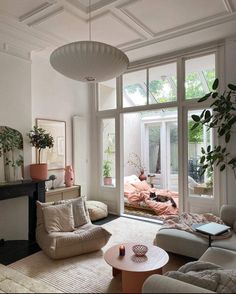 a living room filled with furniture and lots of windows