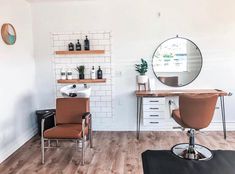 a hair salon with chairs, mirrors and shelves