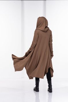 Wool Cape, Knit Cardigan, Cloak with HoodThis asymmetrical and modern cloak with hood has two side pockets, super comfy hood and thumb holes for a fabulous look.The model in the picture is 176cm. ⅼ 5.8 ft. tall and is wearing size S / color: Camel🌟 INFO:• Worldwide EXPRESS shipping – please provide a phone number for shipping documents• US Sizing XS to 4XL – body size chart available below• We offer customization to Personal Measurements & Larger Sizes 5XL, 6XL, 7XL ….🌟 MATERIAL & CARE Cloak With Hood, Shipping Documents, Winter Cloak, Futuristic Clothing, Asymmetrical Cardigan, Cardigan Oversized, Cape Sweater, Hooded Cape, Long Knit Cardigan