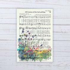 an old sheet music with flowers on it and the words all creatures of our god and king