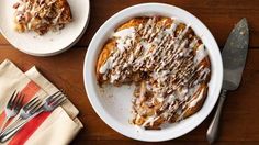 a plate with some food on top of it next to a fork and spoons