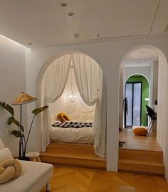 a white bed sitting in the middle of a living room