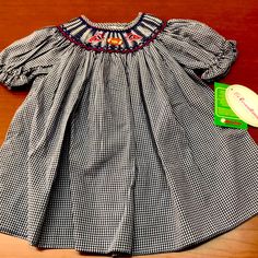 Football Season Is Here!!! This Is A Great Hand Smocked Dress In Navy With Red Trim. Beautiful Hand Smocking Around The Collar. Size 9 Month. Also Has A Wide Hem Which Can Be Let Out If Needed. Casual Smocked Dress With Smocked Back For Playtime, Fitted Blue Smocked Dress For Playtime, Blue Embroidered Cotton Smocked Dress, Cotton Smocked Dress With Smocked Cuffs For Playtime, Blue Smocked Dress With Cuffs For Playtime, Blue Smocked Dress With Smocked Cuffs For Playtime, Blue Dress With Smocked Bodice For Playtime, Cute Blue Smocked Dress, Rosalina Dress