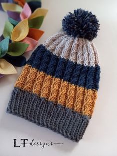 a knitted hat sitting on top of a white table