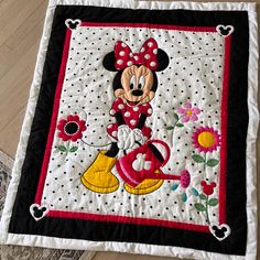 a mickey mouse quilt is on the floor