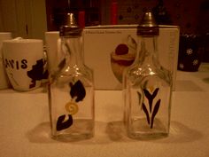 two empty glass bottles sitting on top of a counter