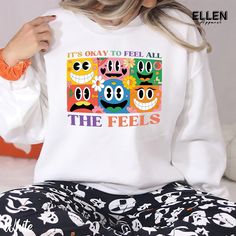 Express yourself with our vibrant "It's Okay to Feel All the Feels" t-shirt. This colorful design features whimsical cartoon faces representing various emotions, reminding us that all feelings are valid. Spread positivity and emotional awareness with this comfortable, eye-catching shirt for all ages. ---------------------------------------------------------------------------- PRODUCT DETAILS & SIZING This unisex tee is made for all-day comfort. It's crafted from super soft, lightweight 100% cotton (solid colors) or a cotton-polyester blend (heathered colors) that feels great against your skin. No itchy side seams or annoying tag thanks to the tear-away label. Plus, the classic crewneck style looks polished enough for those special dad moments, but comfy enough for everyday wear. - Ultra-so Multicolor Cartoon Print Crew Neck Top, Multicolor Funny Print T-shirt For Streetwear, Multicolor Funny Print Crew Neck T-shirt, Cotton Tops With Multicolor Cartoon Print, Cotton Multicolor Cartoon Print Tops, Cotton Tops With Cartoon Print In Multicolor, Fun Multicolor Tops With Graphic Print, Relaxed Fit Multicolor Tops With Cartoon Print, Multicolor Cartoon Print Relaxed Fit Tops