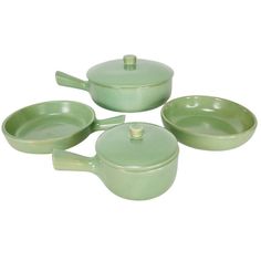 four green pots and pans on a white background