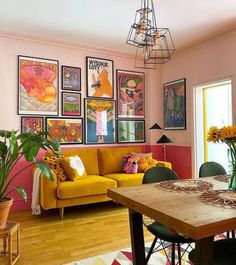 a living room filled with furniture and pictures on the wall above it's wooden table