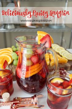 a pitcher filled with fruit next to two glasses