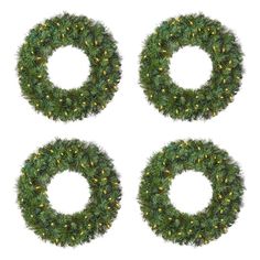 three christmas wreaths with lights on them