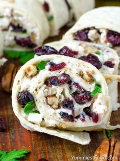 cranberry and pecan burritos on a cutting board