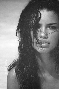 a black and white photo of a woman with wet hair