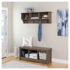 an entryway with a bench and shelves on the wall