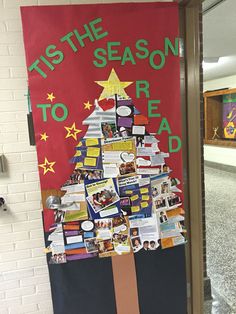 a decorated christmas tree is on display in front of a door that says tis the season to read