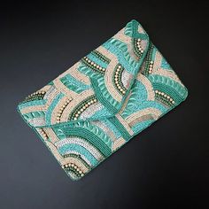 Hi ladies, these beautiful clutch bags will make you fall in love with the colors and design.  Carry with your matching dresses and wait for a million compliments. Shades of teal and light peach, add to the whole look and the craftsmanship is topnotch.   Clutches come with detachable string, which you can add if you like and it is amazing without it too.  The size of this clutch is 9x6inch and the rear size is a comfortable cotton fabric so that it is easy to carry it with your dresses. This can be an amazing gift this Thanksgiving, Christmas, and New Year.  A gift wrap option is also available and we will love to pack it for your loved ones! For the first time, we are adding an amazing collection of clutches to our store, all handmade with love in India. Handmade Green Evening Bag For Party, Green Clutch Evening Bag For Gift, Handmade Green Rectangular Clutch, Handmade Green Rectangular Evening Bag, Blue Handmade Bag For Events, Handmade Blue Bag For Events, Elegant Green Evening Bag For Summer, Elegant Green Summer Evening Bag, Handmade Blue Clutch For Party